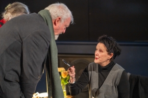 Catherine McKinnon signs copies of her novel. Photo by Greg Jackson. 