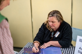 Jasmine Seymour signs copies of her books. Photo by Greg Jackson. 